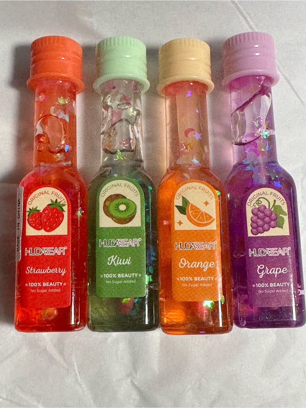 HUDA BEAR Fruit-Scented Lip Gloss Set — Strawberry, Kiwi, Orange, Grape